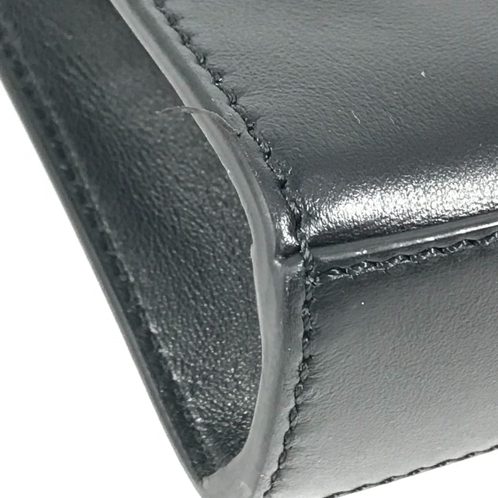 Close-up of a black leather wallet corner with visible stitching