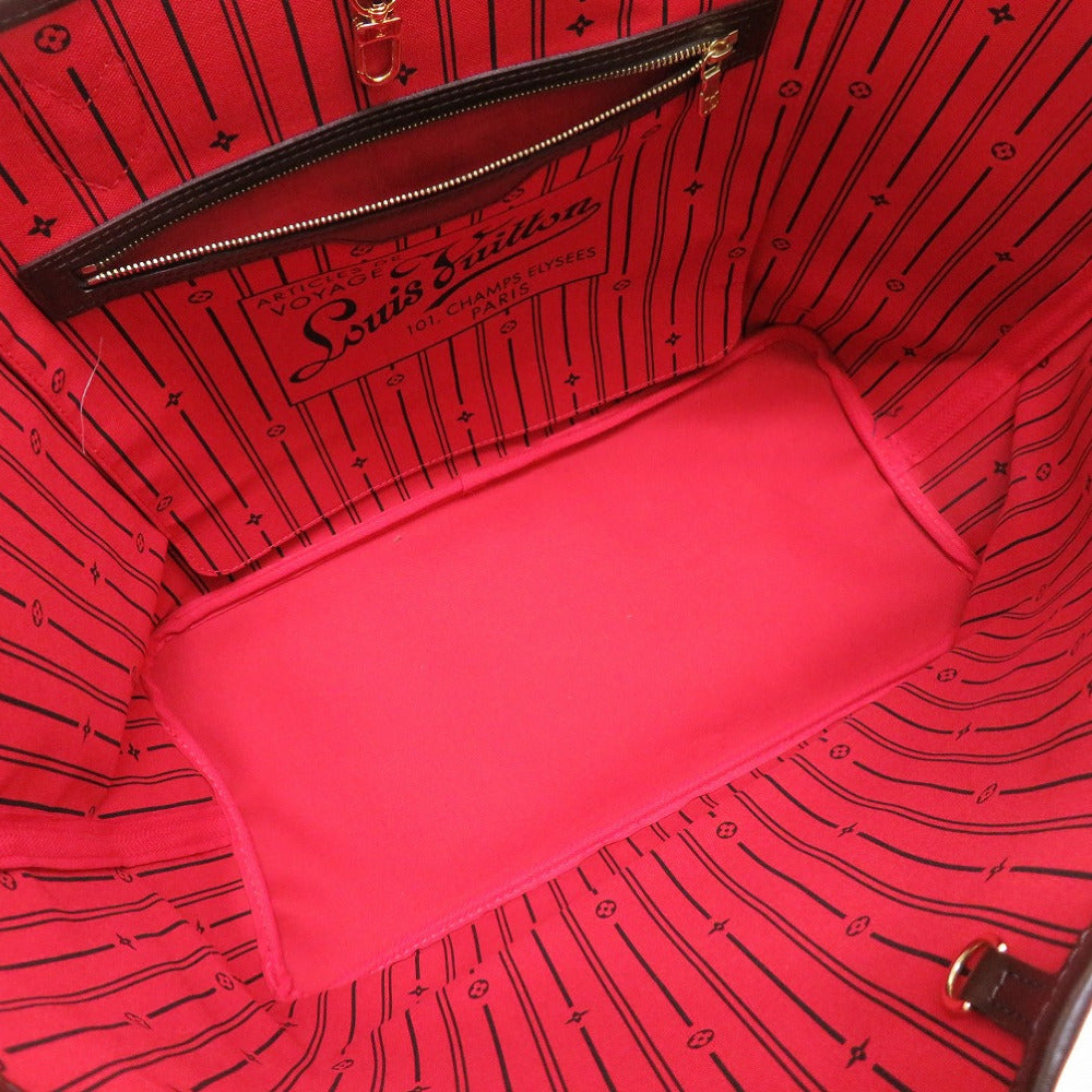 Red interior of a Louis Vuitton handbag with visible branding.
