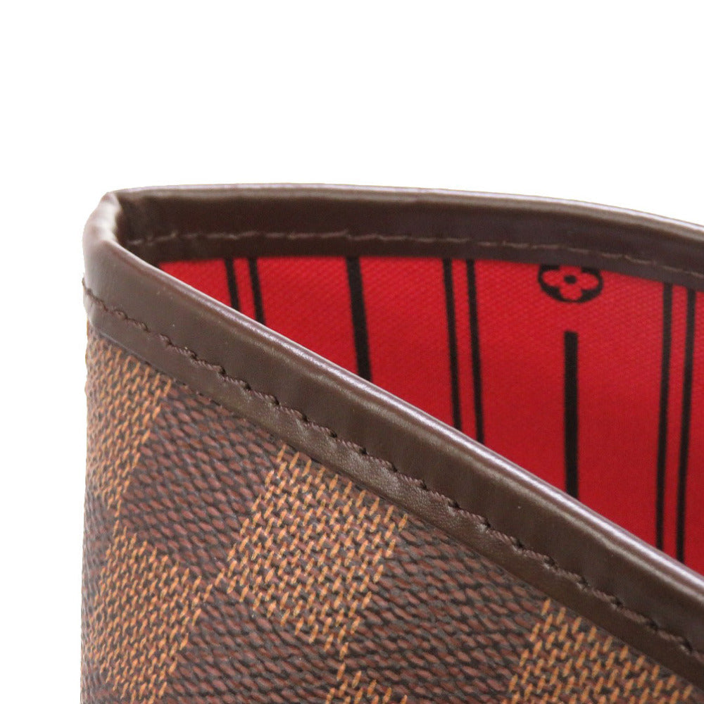 Close-up of a brown patterned wallet with a red interior