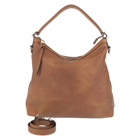 Brown leather handbag with a detachable strap on a white background