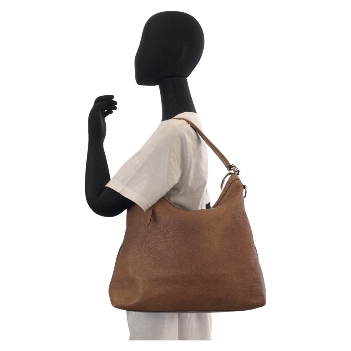 Brown leather handbag on a mannequin with a white background