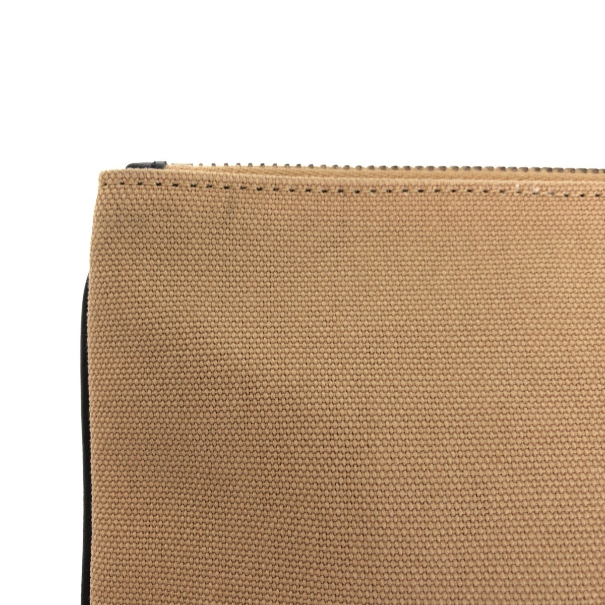 Close-up of a brown fabric pouch with a zipper on a white background