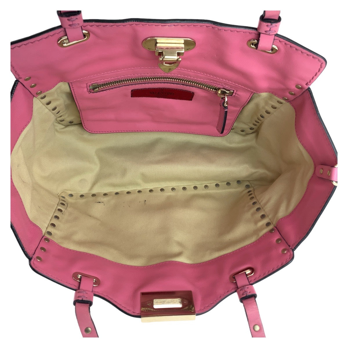 Pink handbag with beige interior on a white background