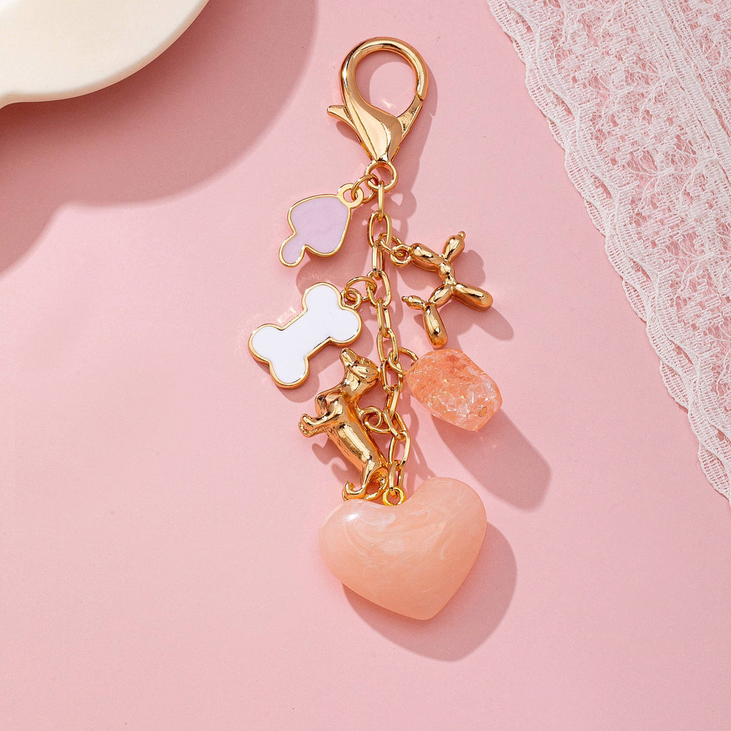 Keychain with heart and animal charms on a pink background