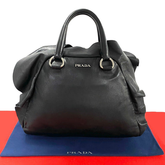 Black Prada handbag on a red and blue background