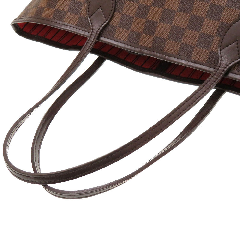 Close-up of a brown checkered handbag with a strap on a white background