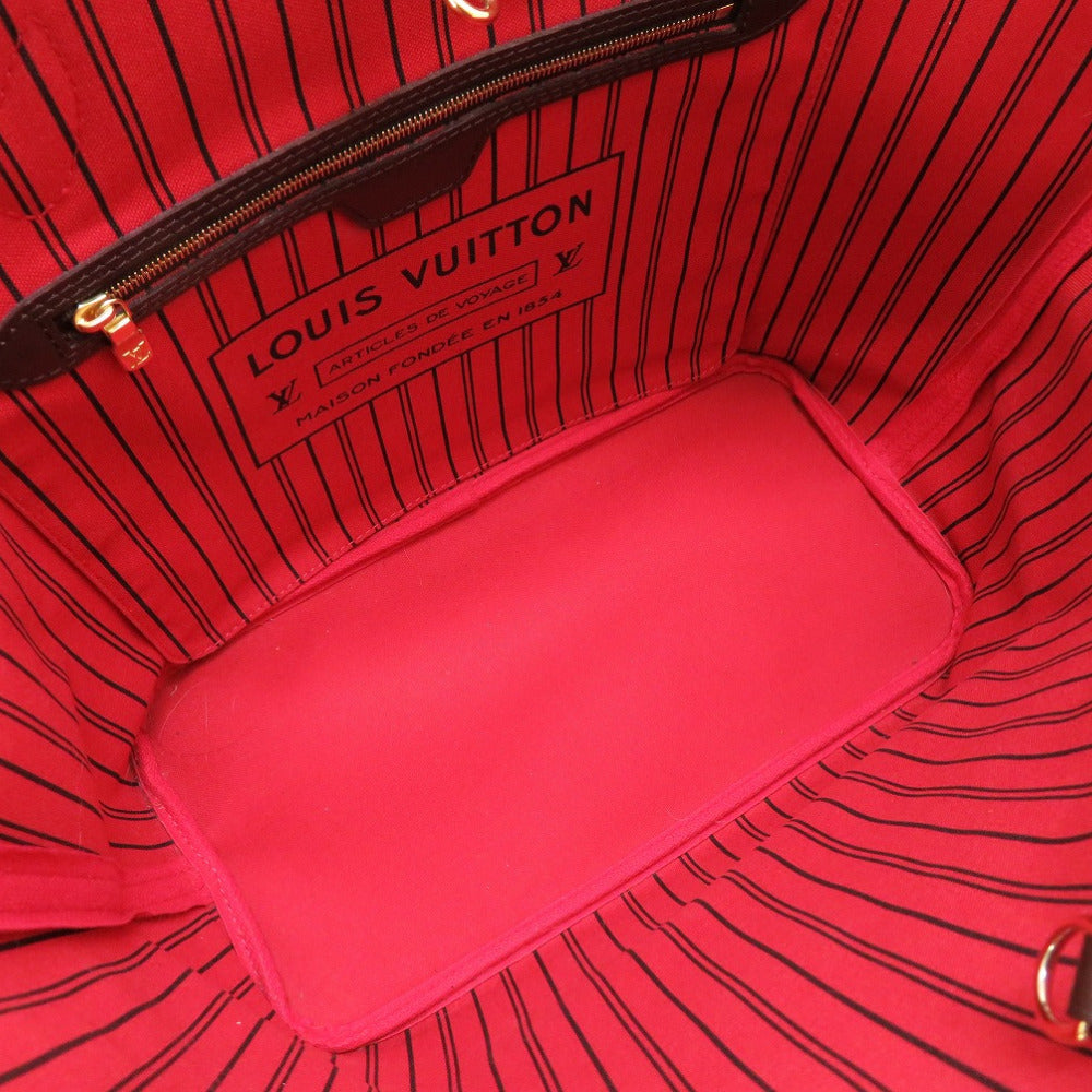 Red interior of a Louis Vuitton bag with visible branding.