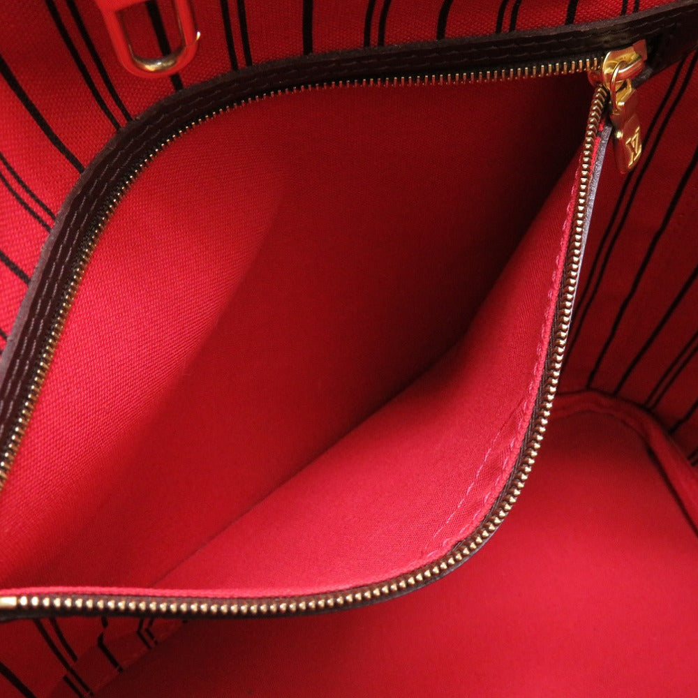 Red handbag with gold zipper on a red background