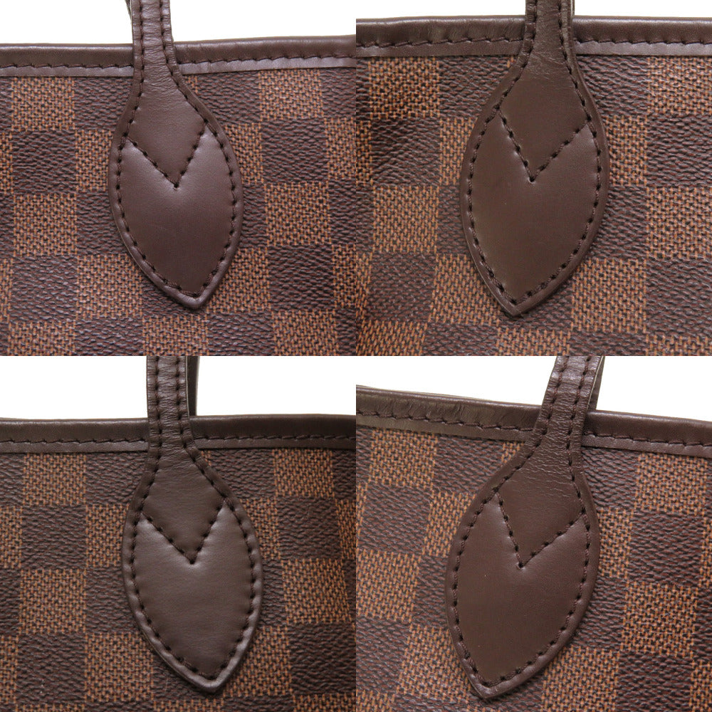 Close-up of a brown checkered handbag with leather handles on a white background