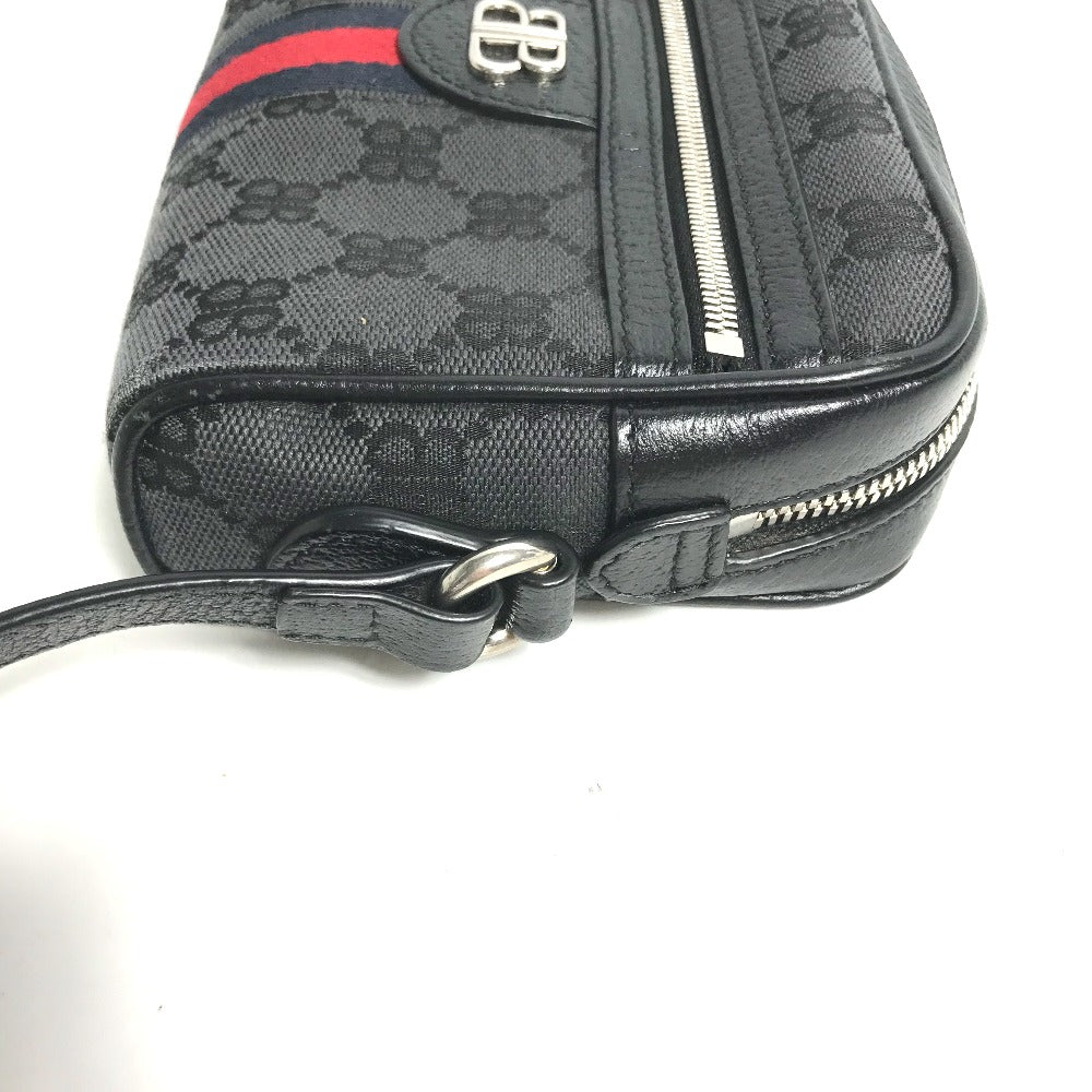 Black patterned handbag with a red stripe on a white background