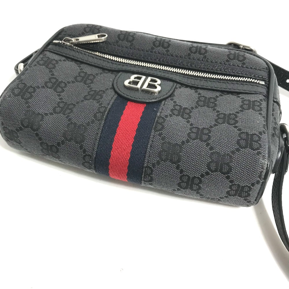 Black patterned handbag with a red and blue stripe on a white background