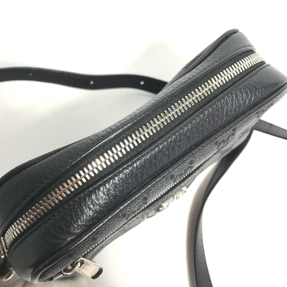 Black leather handbag with silver zippers on a white background