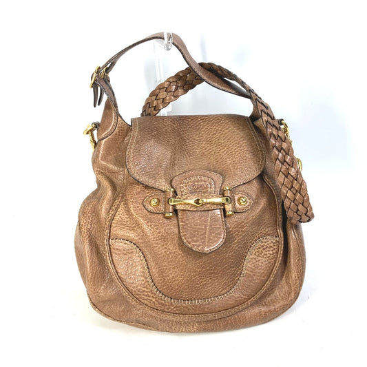 Brown leather handbag with braided handle on a white background