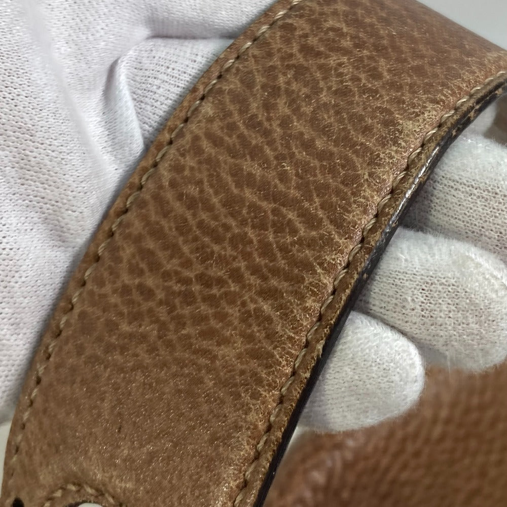Close-up of a brown leather strap on a white background