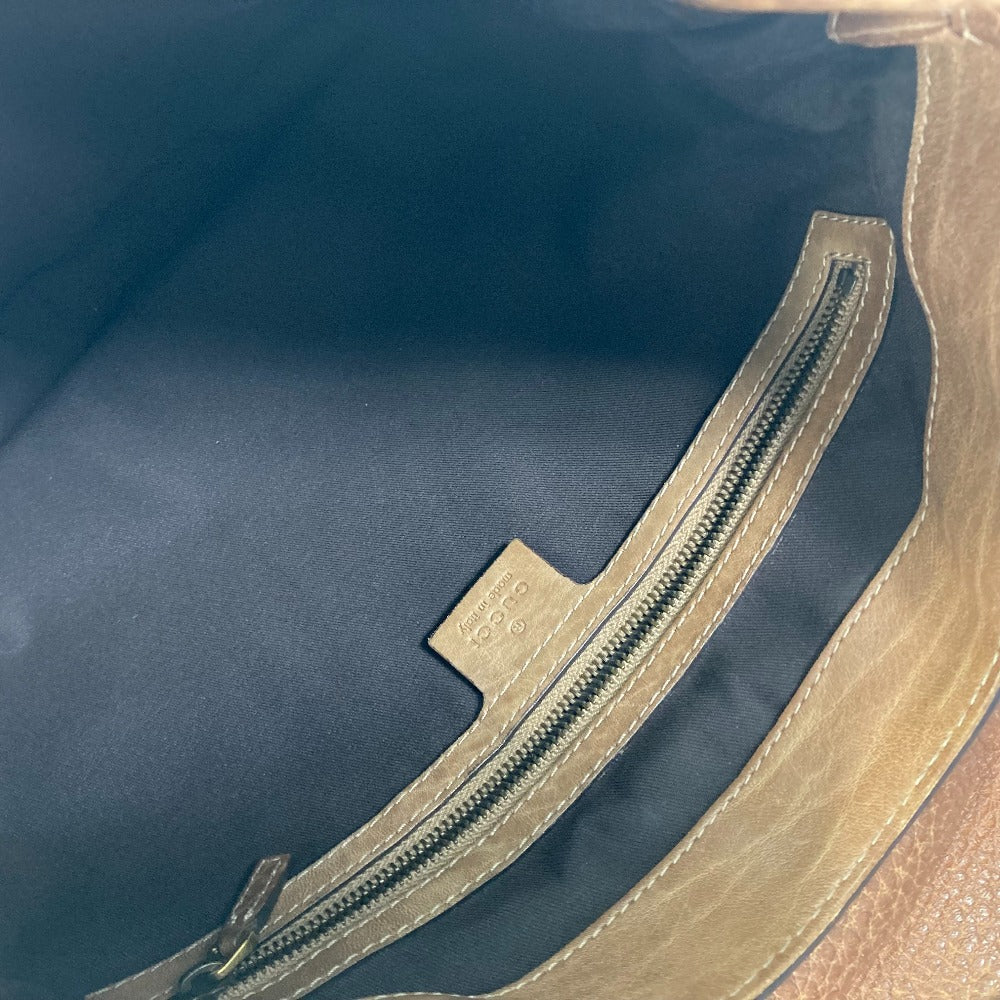 Close-up of a zipper on a blue and brown bag