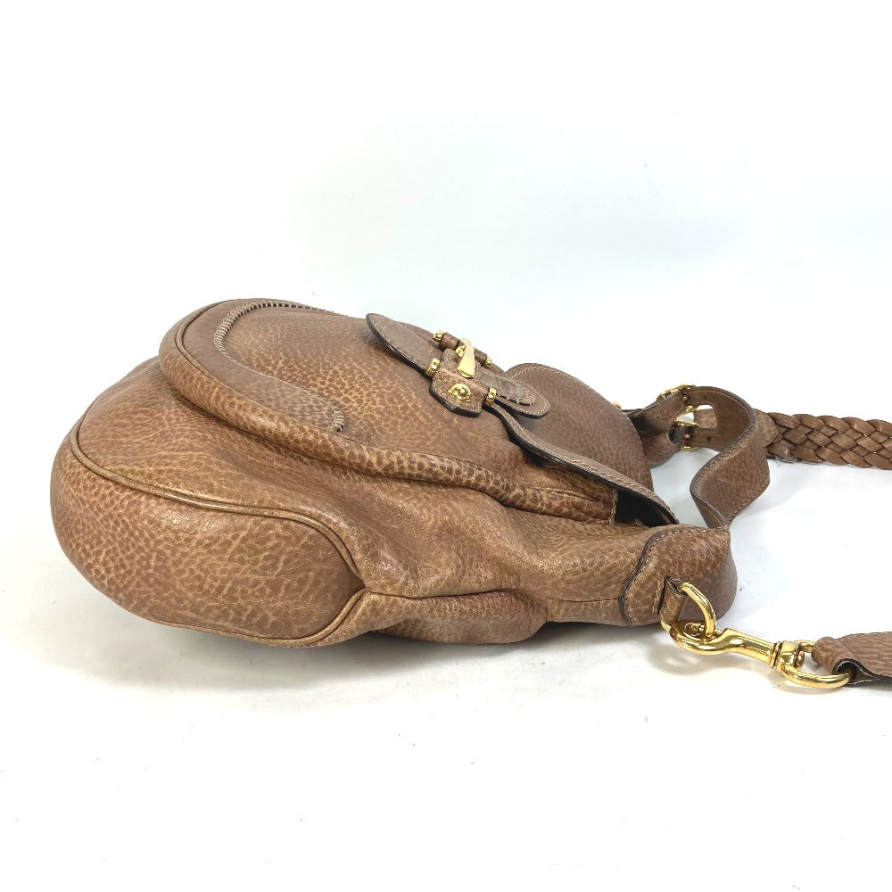 Brown leather handbag with gold clasp on a white background