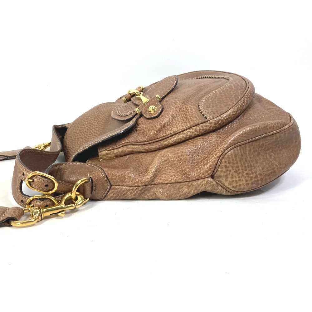 Brown leather handbag with gold accents on a white background