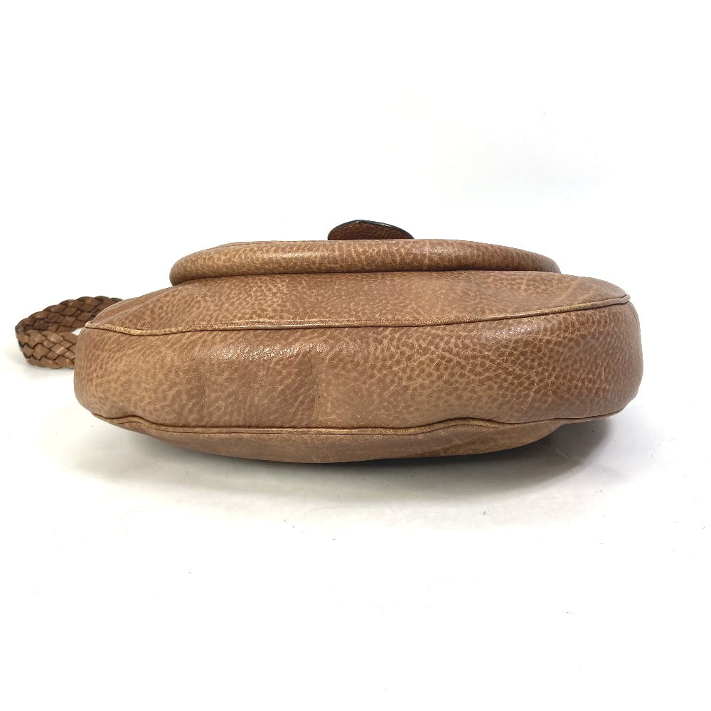 Brown leather bag with a strap on a white background
