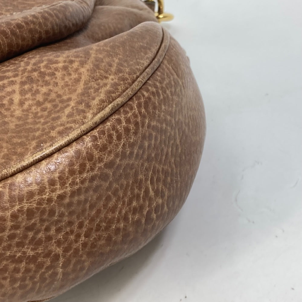 Close-up of a brown leather handbag on a white background