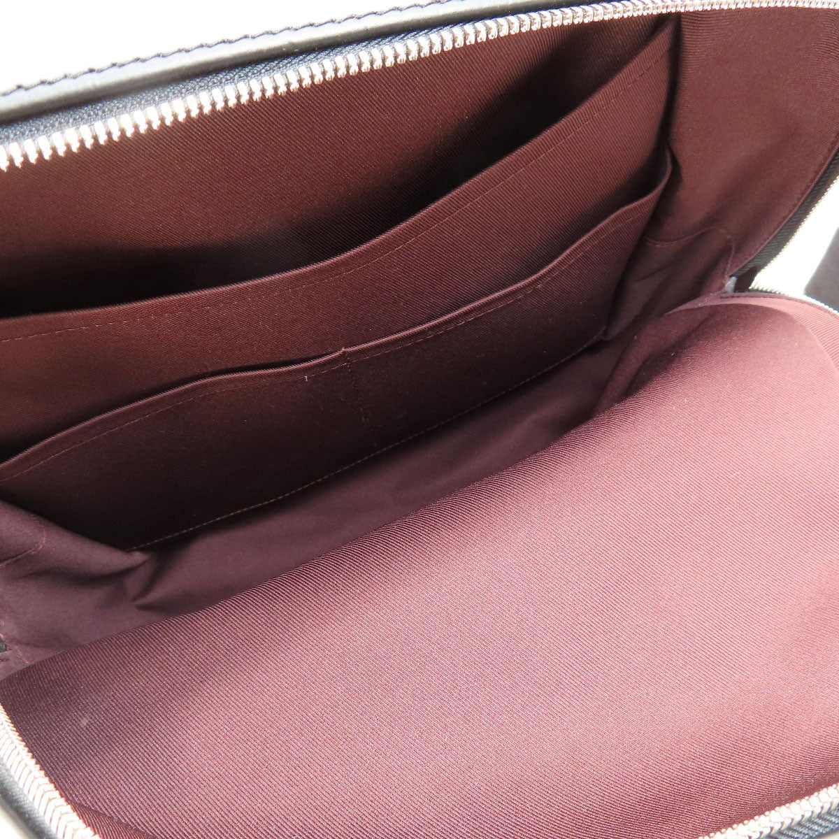 Close-up of a maroon fabric interior of a bag