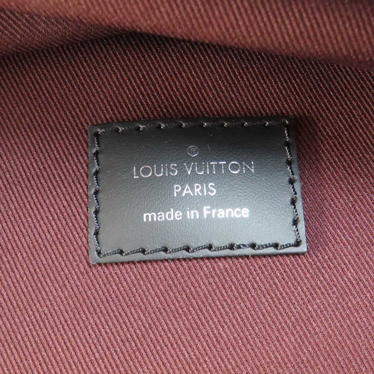 Louis Vuitton label on a textured fabric background