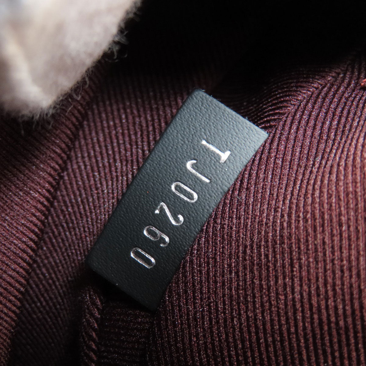 Textured fabric with a label displaying 'TJ0260' on a dark background