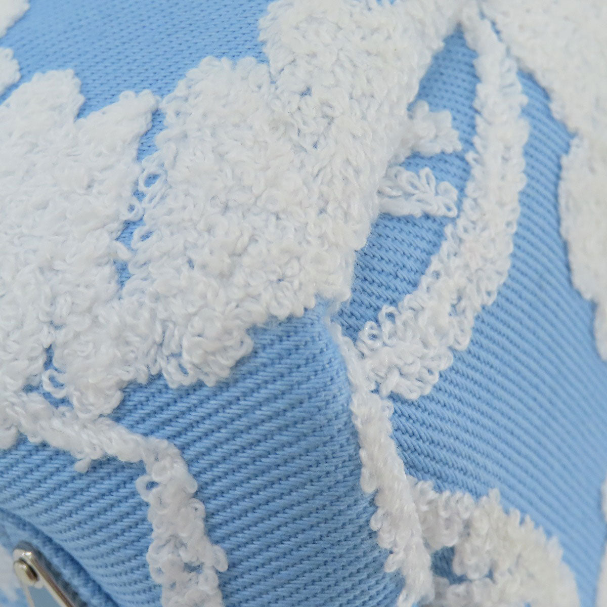 Close-up of a blue fabric with white lace detailing