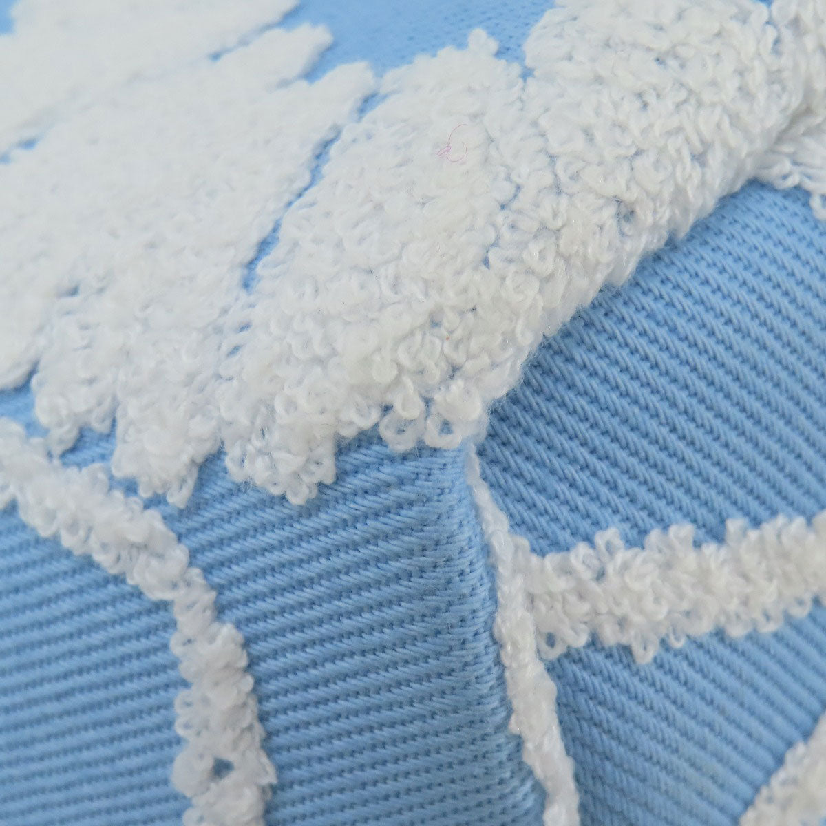 Close-up of white textured fabric on a blue background
