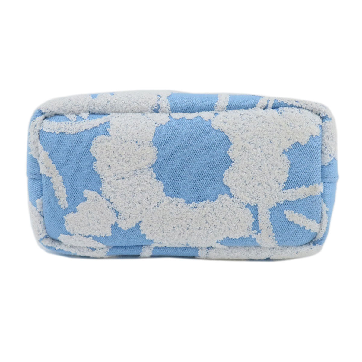 Rectangular cushion with white floral pattern on a blue background