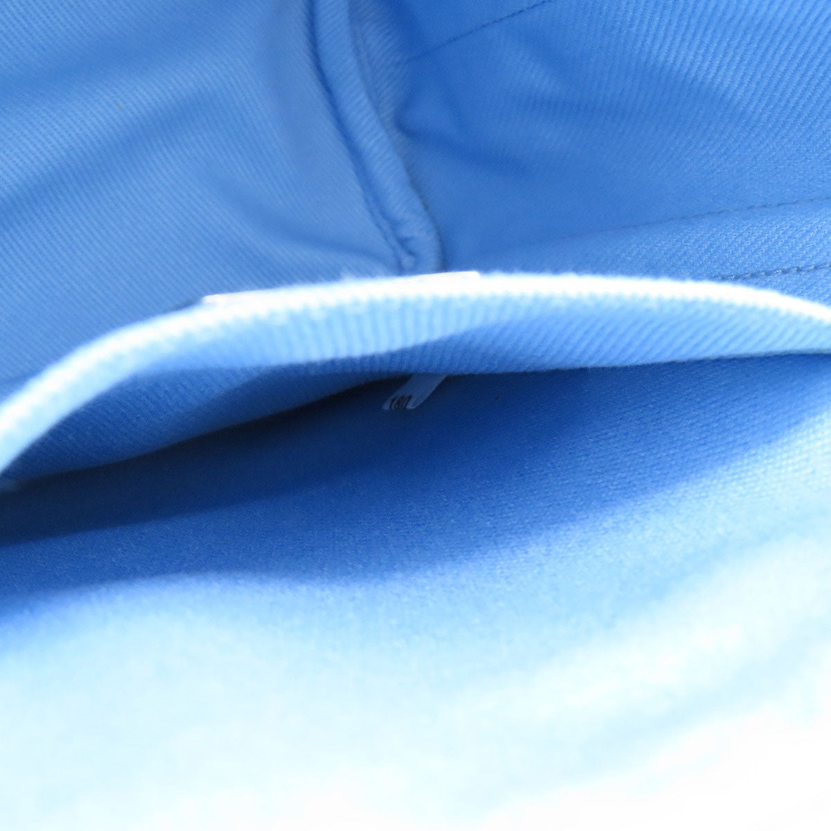 Close-up of blue fabric with a white trim