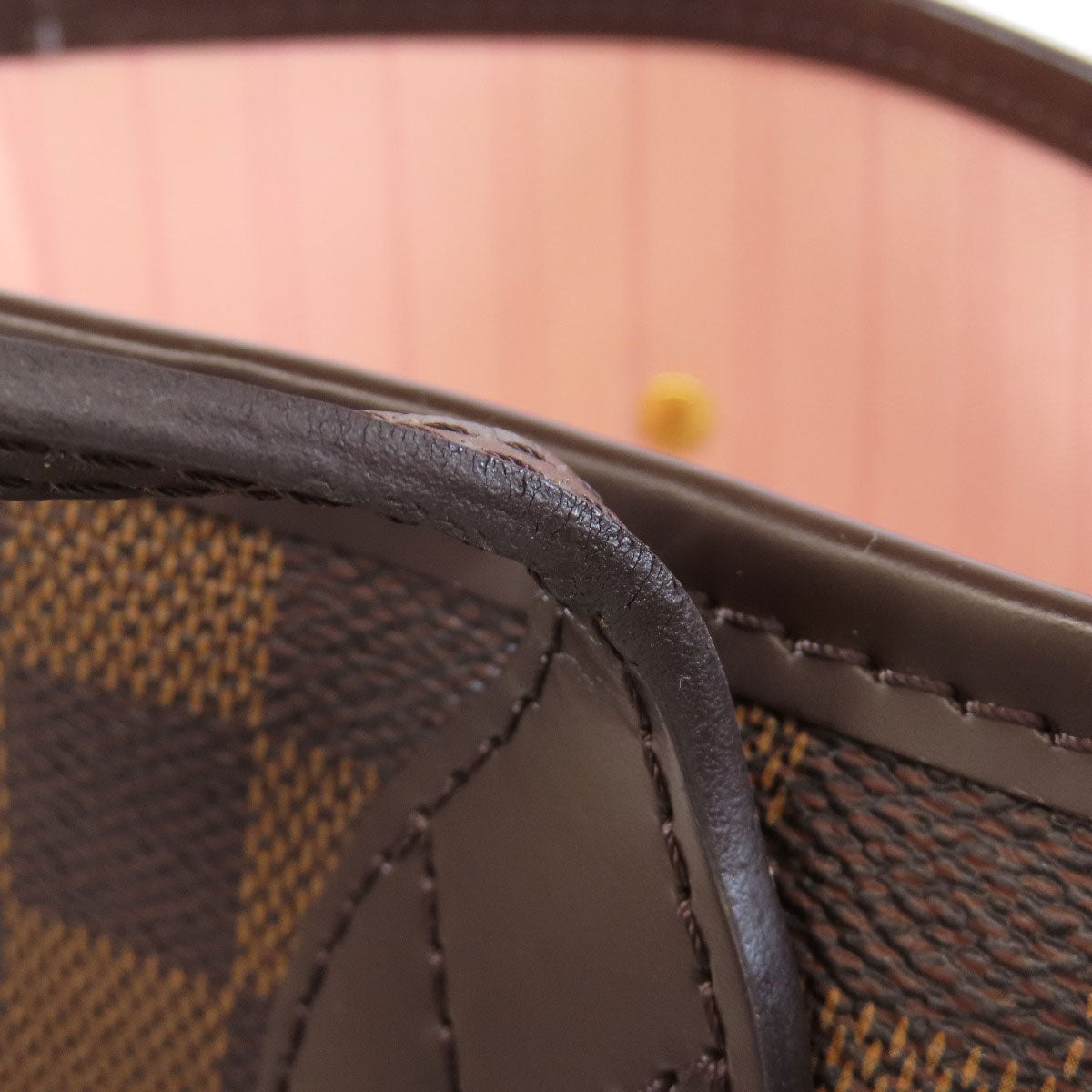 Close-up of a brown leather bag with visible stitching
