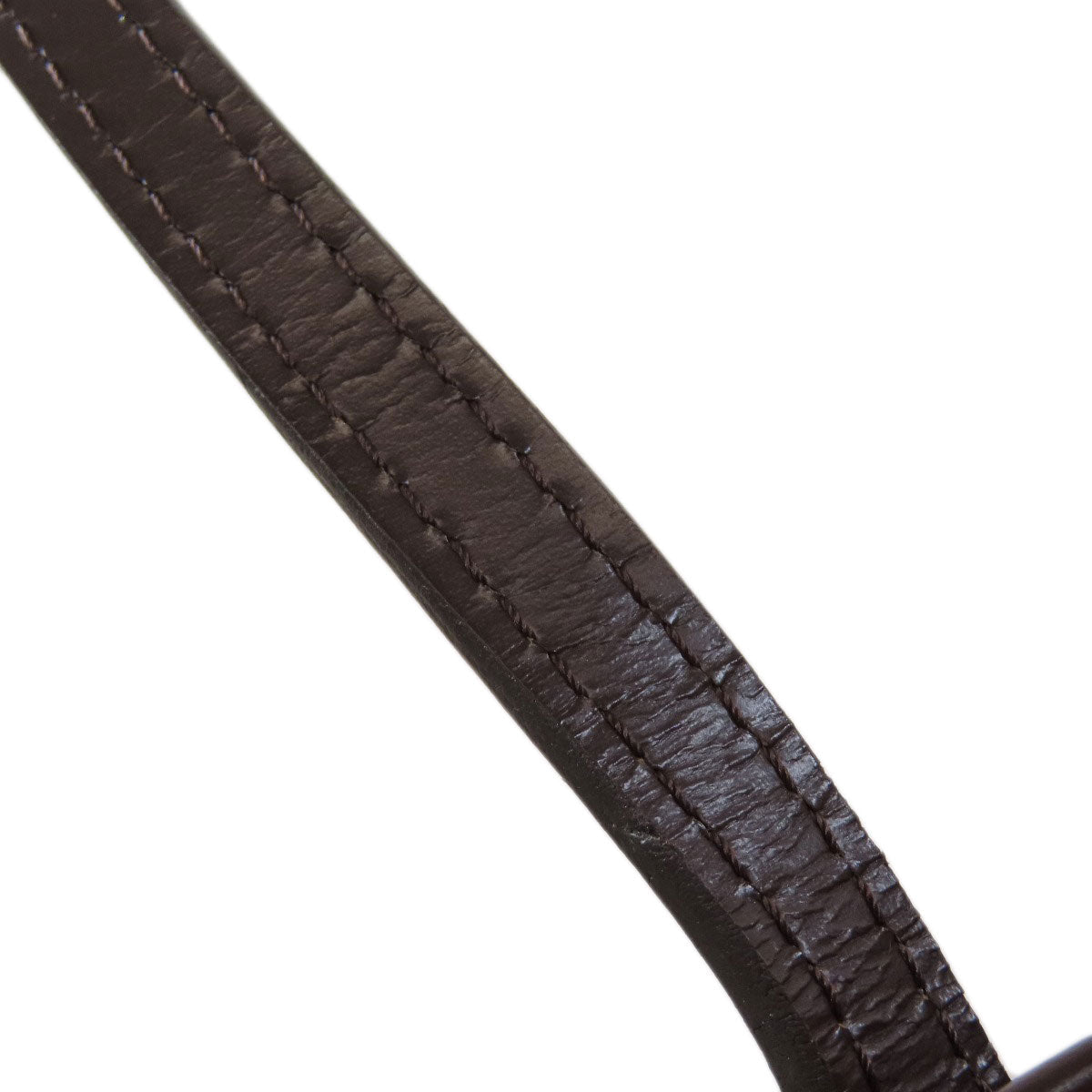 Close-up of a brown leather belt strap on a white background