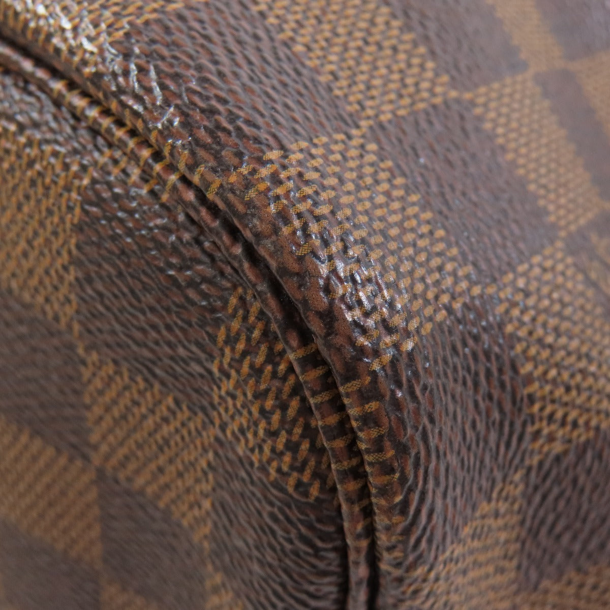 Close-up of a brown textured fabric with a diamond pattern