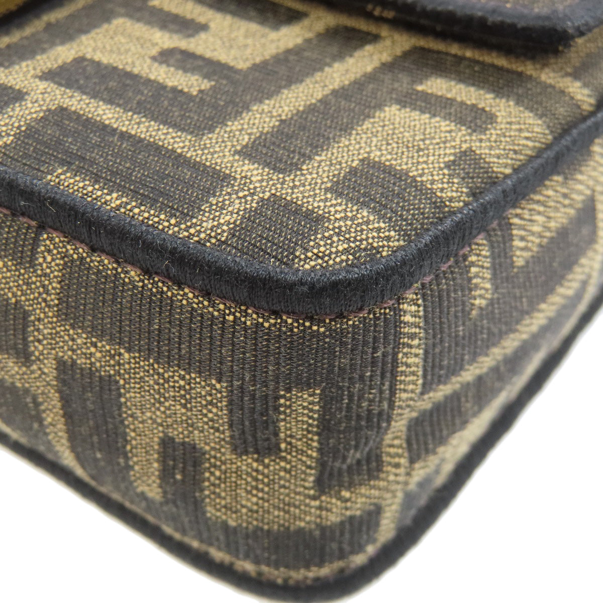 Close-up of a patterned fabric with a prominent logo on a white background