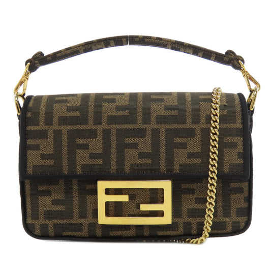 Designer handbag with gold chain and logo on a white background
