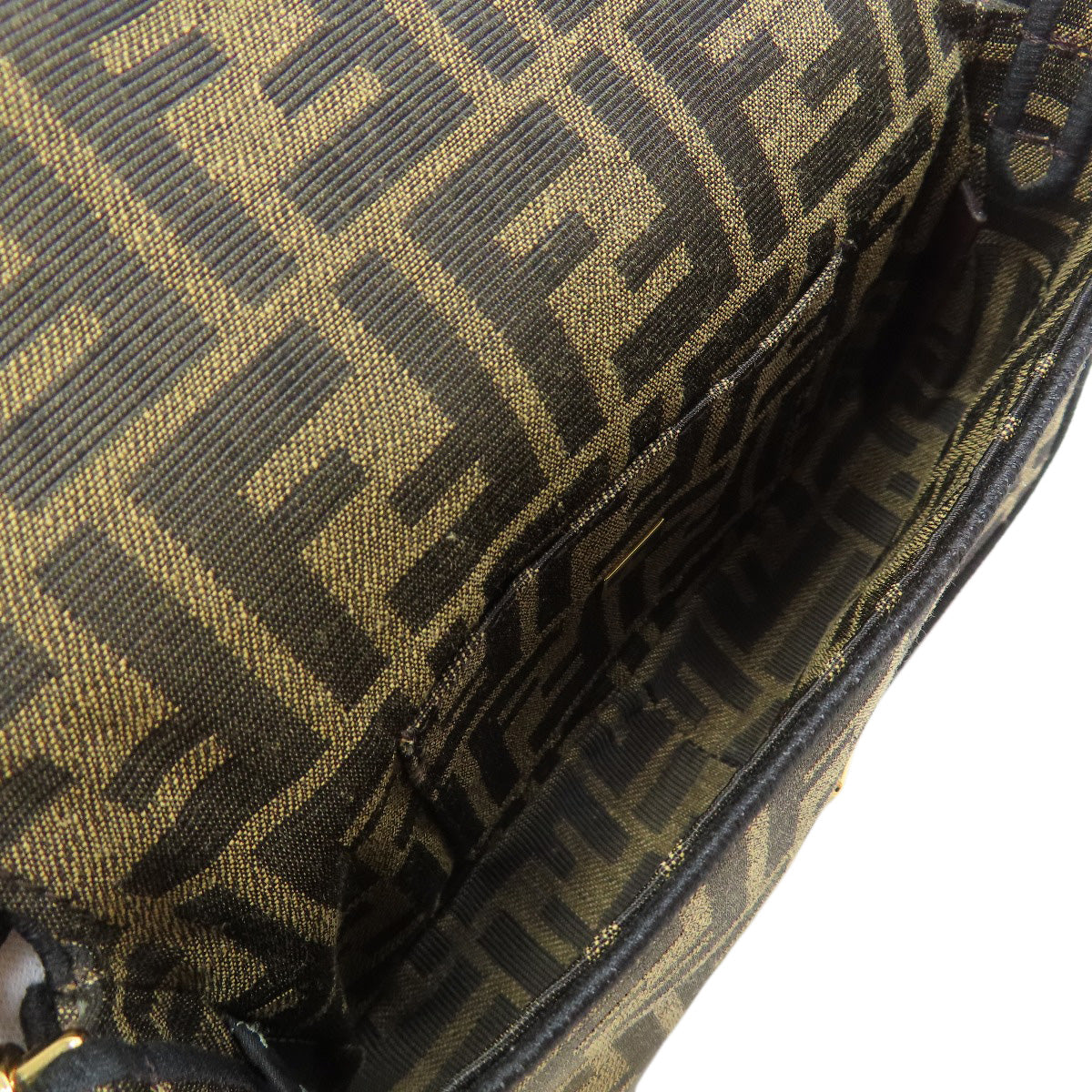 Close-up of a patterned bag with a prominent brand logo.