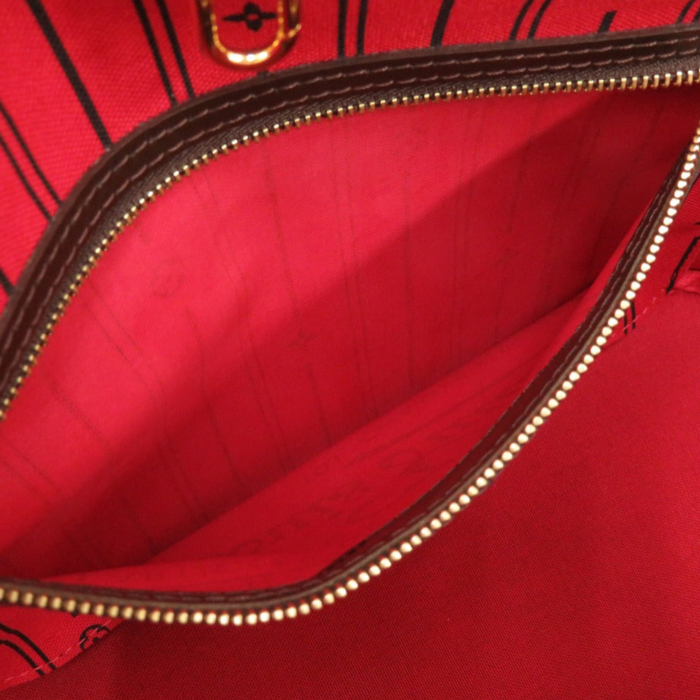 Close-up of a red bag with a brown zipper