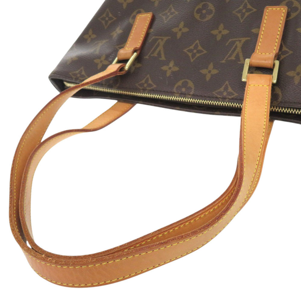 Close-up of a brown leather handbag with visible brand logo on a white background