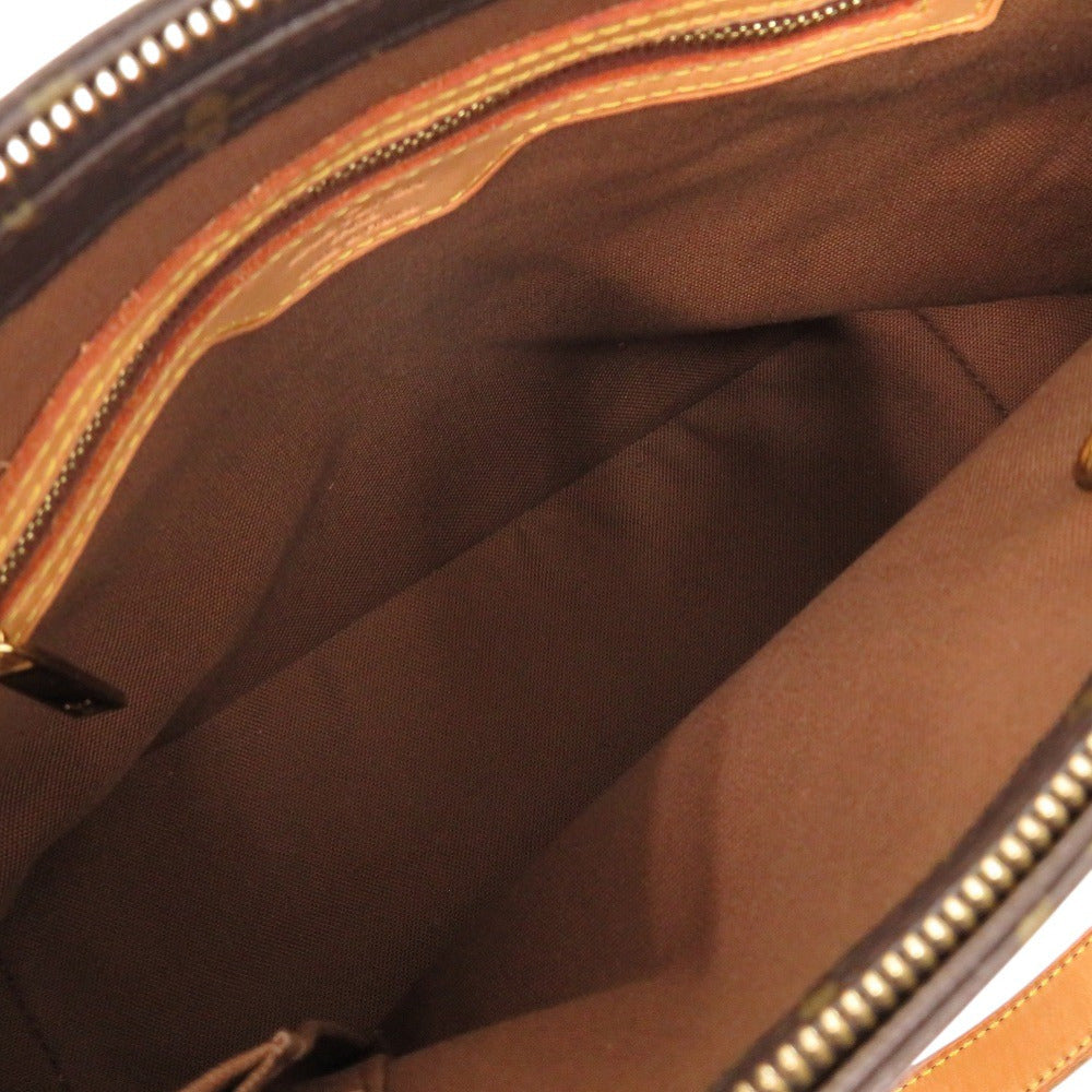 Close-up of a brown bag with gold zipper details
