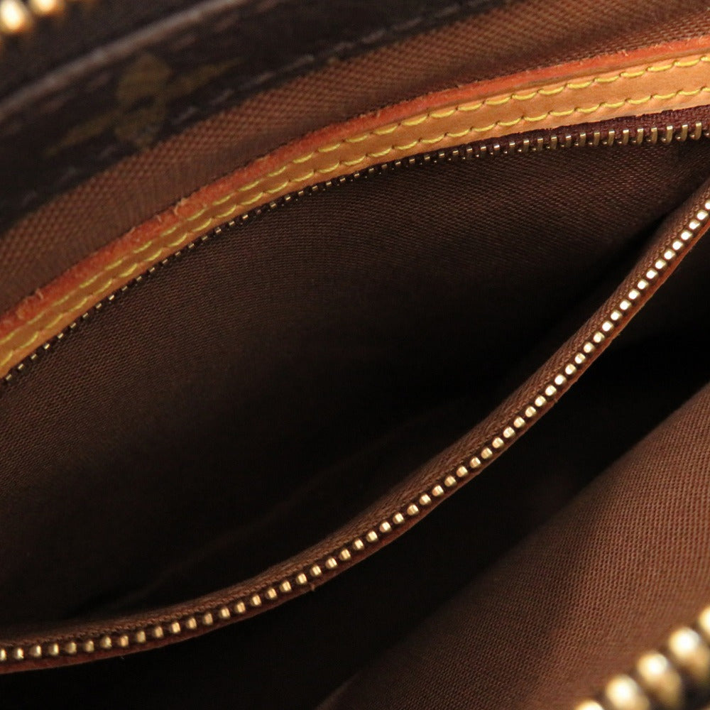 Close-up of a brown leather bag with gold stitching