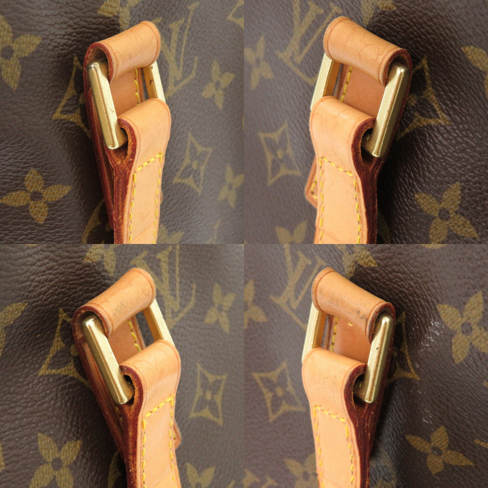Close-up of a brown leather handle with gold hardware on a patterned background