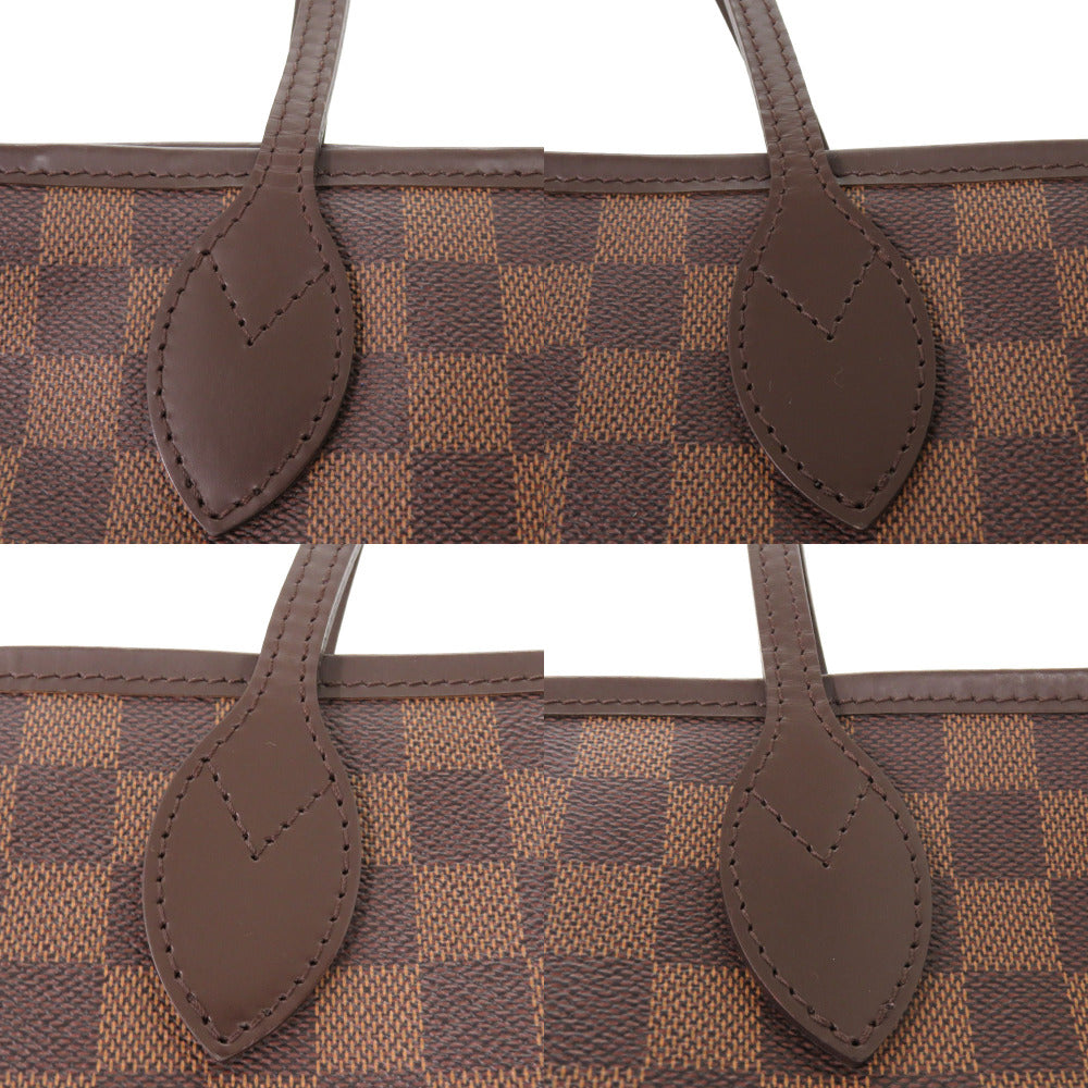 Close-up of a brown and beige checkered handbag with leather handles on a white background