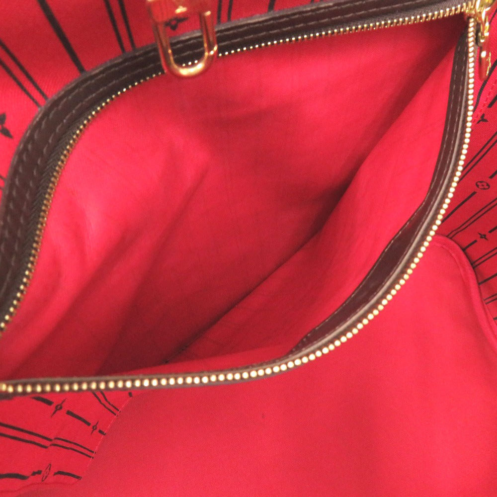 Close-up of a red handbag with a gold zipper