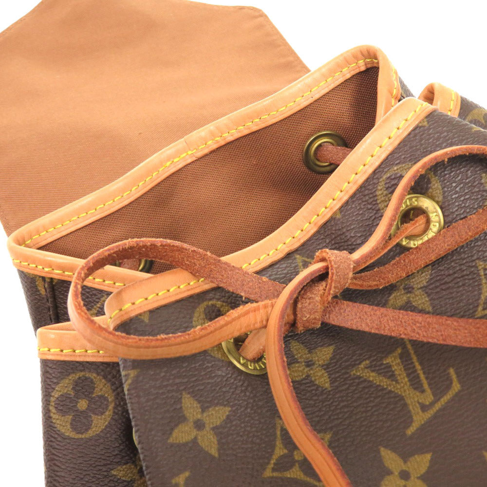 Close-up of a brown leather bag with orange stitching and gold hardware.