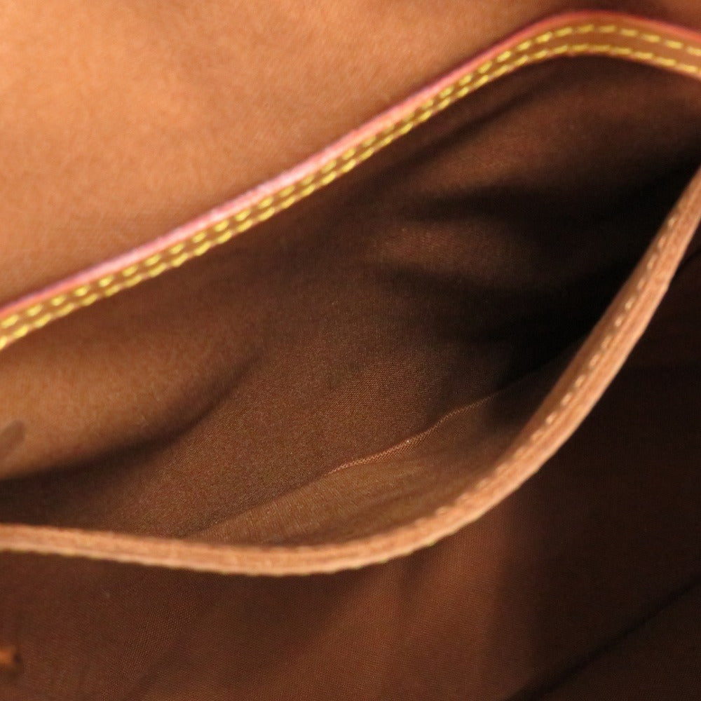 Close-up of brown leather bag with gold stitching