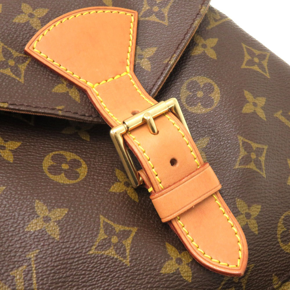 Close-up of a brown leather strap with gold buckle on a patterned background
