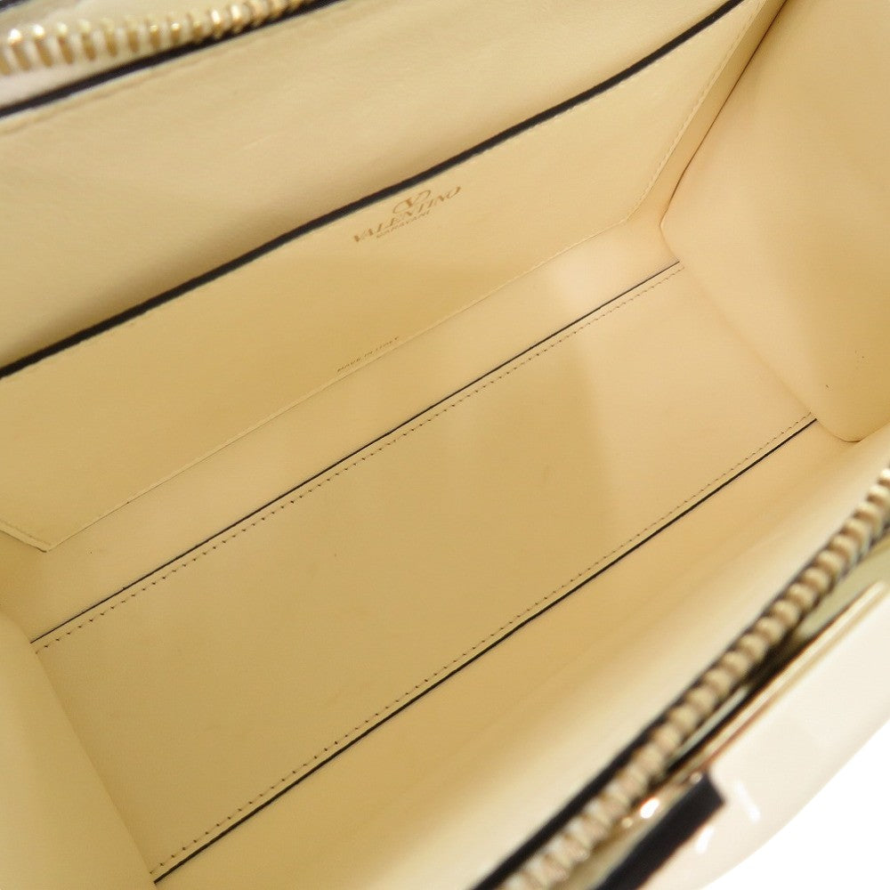 Close-up of a beige leather handbag interior with visible stitching and brand logo.