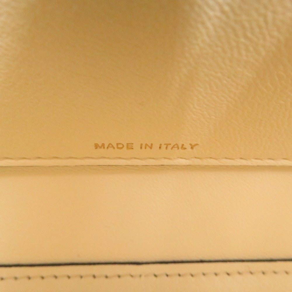 Close-up of beige leather with 'MADE IN ITALY' engraving