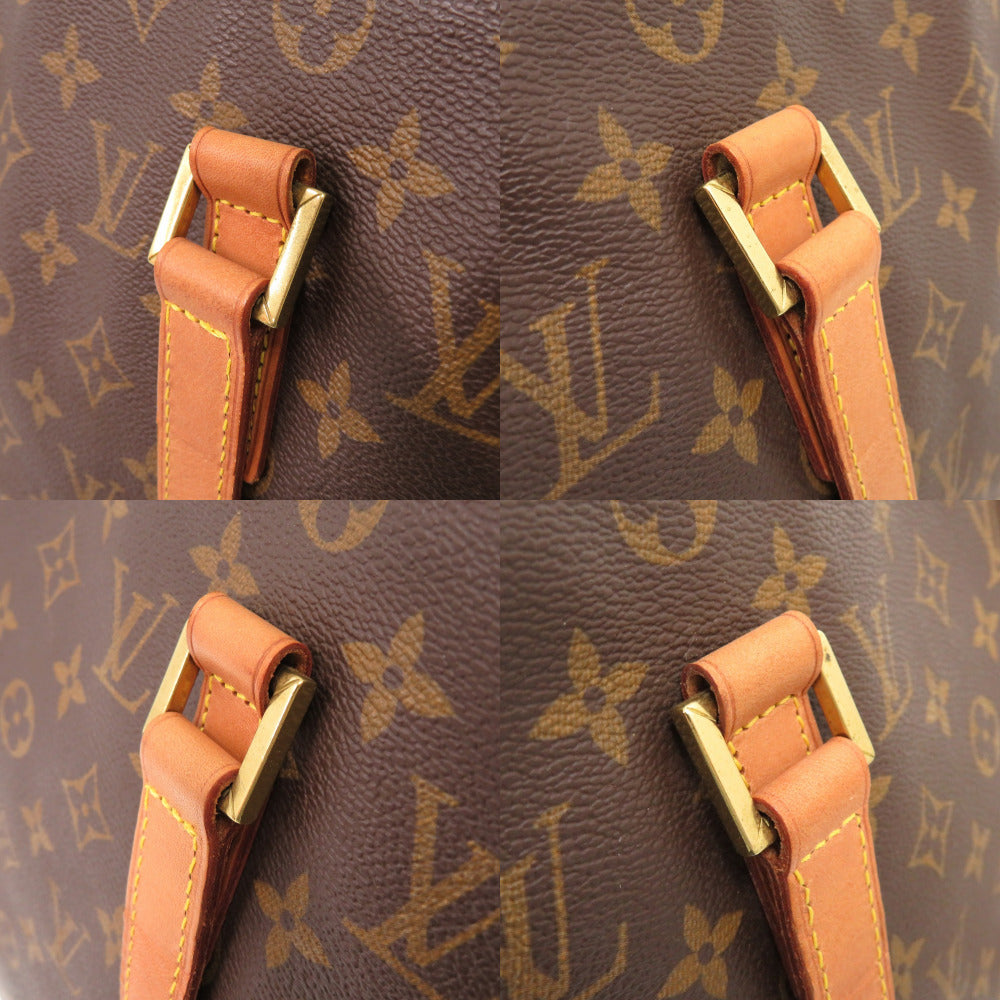 Close-up of a brown leather strap with gold hardware on a Louis Vuitton monogram bag.