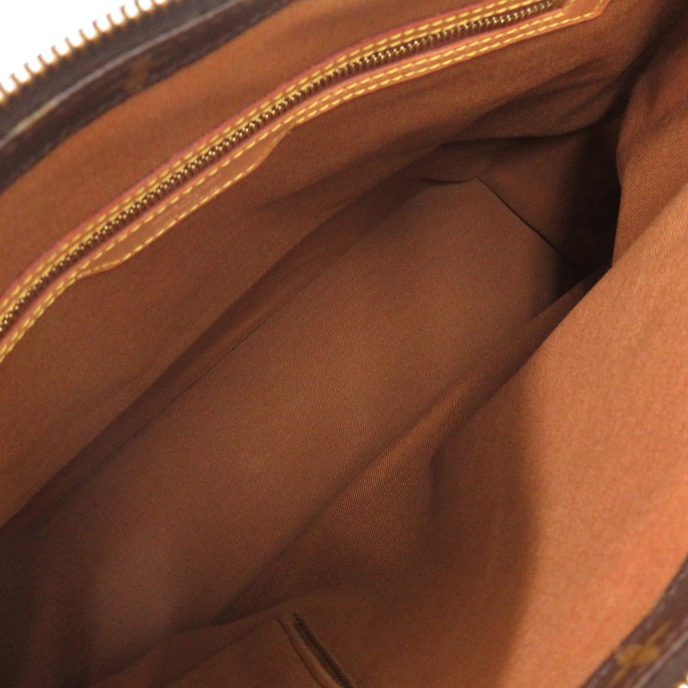 Close-up of a brown leather bag with gold zipper